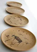 Stoneware cave art-themed plates